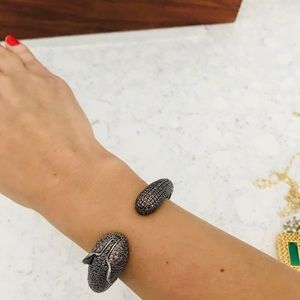 Pink stones and silver serpent cuff.